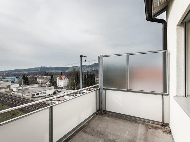 metal railing, floored balcony, glass door, city view