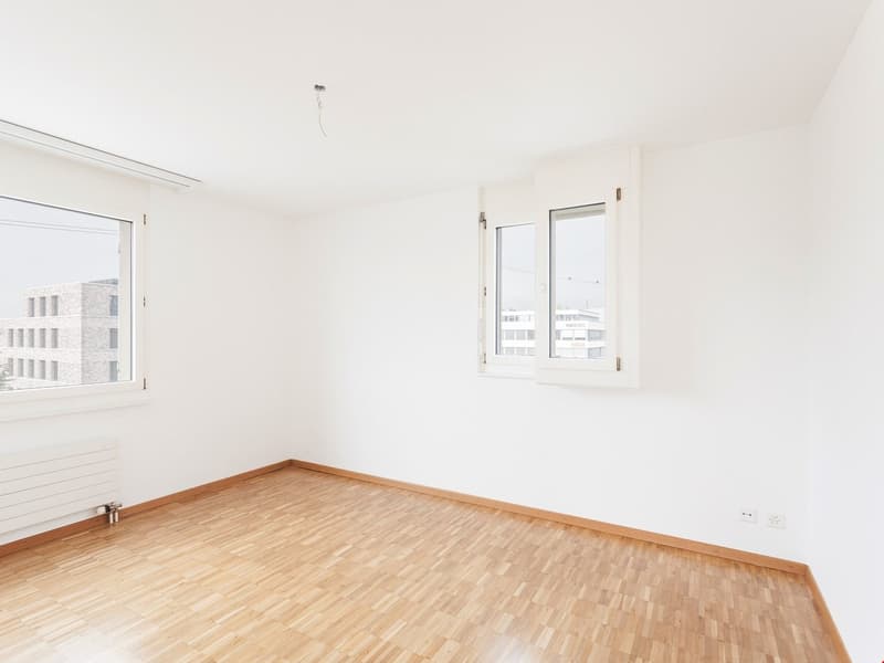 empty room, hardwood floors, two windows, two power outlets