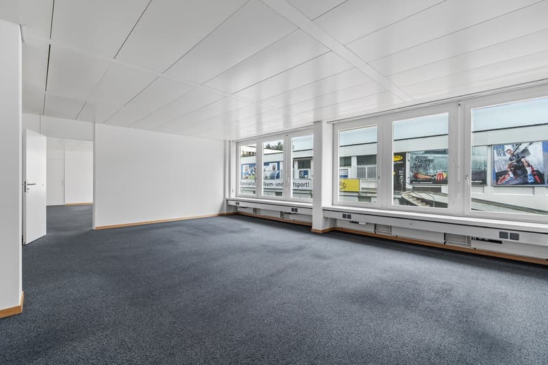 empty room, white walls, grey flooring, large windows