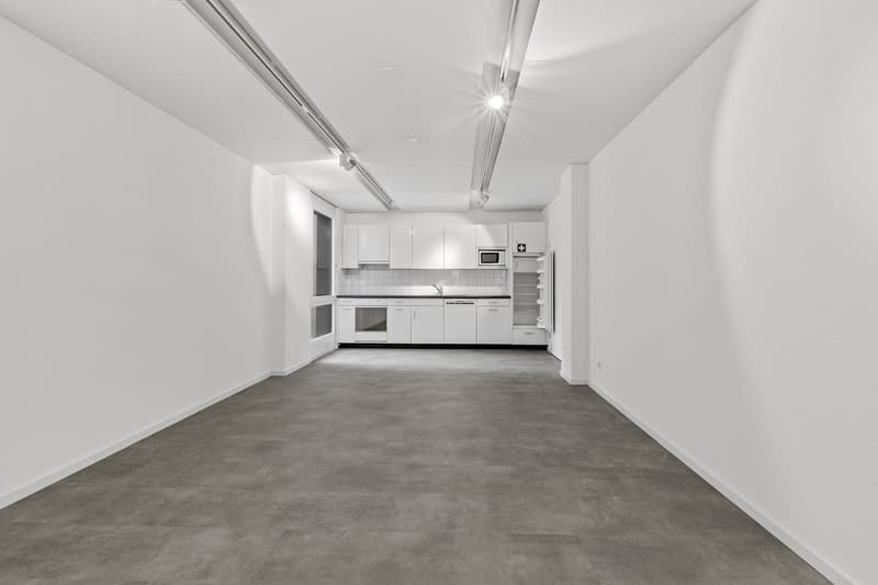 Empty kitchen with white cabinets, stainless steel sink, oven, microwave, refrigerator