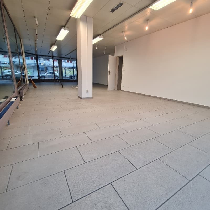 open space, tiled floor, high ceilings, large windows, bright lighting