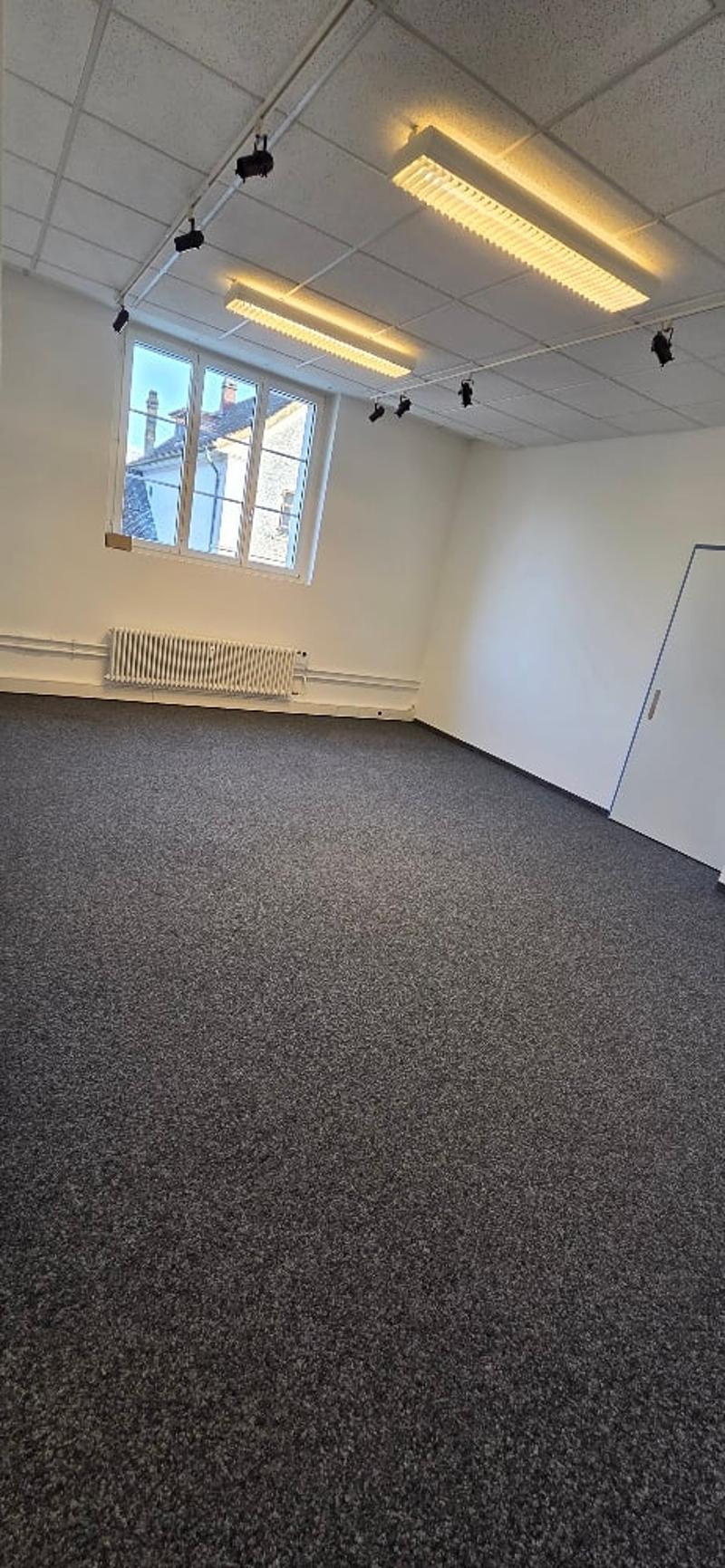 empty room, white walls, ceiling lights, radiator, window