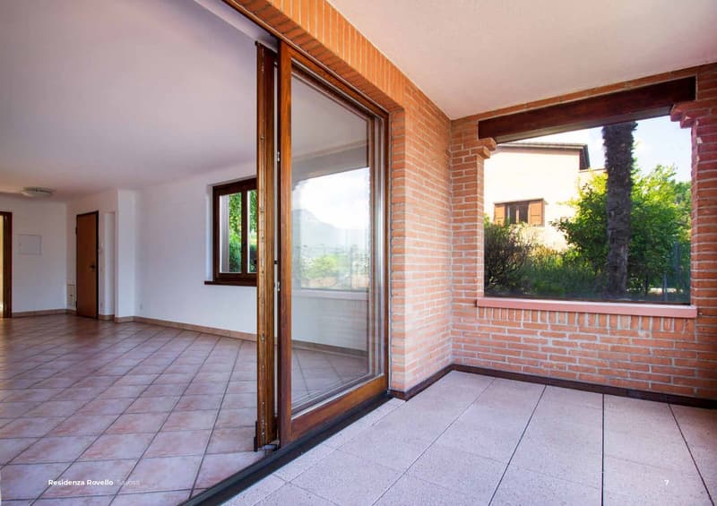 balcony access, sliding glass doors, brick walls, tiled floor