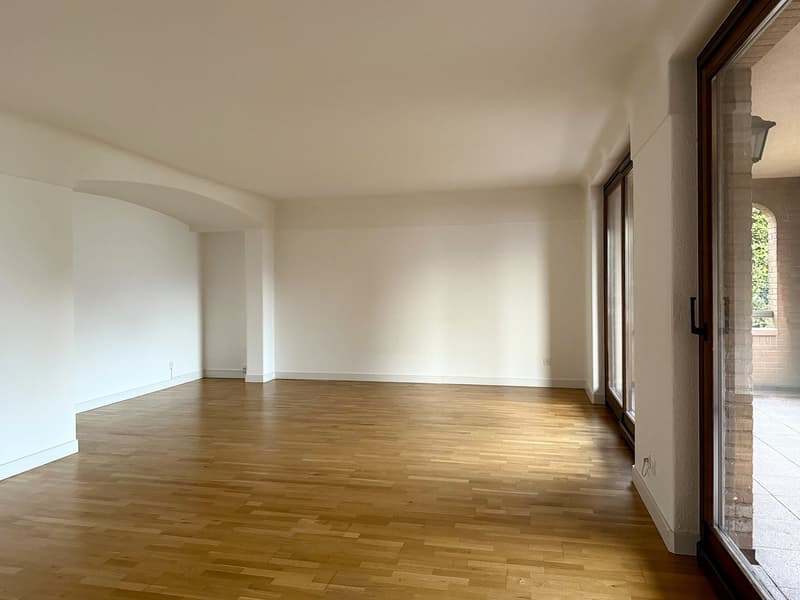 empty room, wooden floors, white walls, sliding glass doors, balcony access