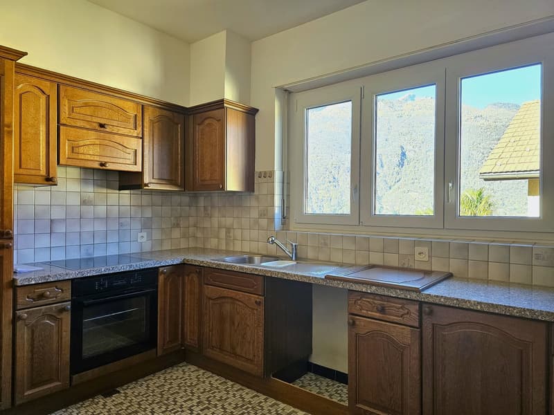 modern kitchen, wooden cabinets, tiled backsplash, large windows, granite countertops, double sink