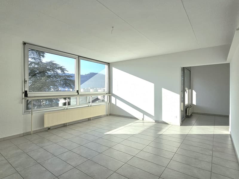 large windows, radiator, tiled flooring
