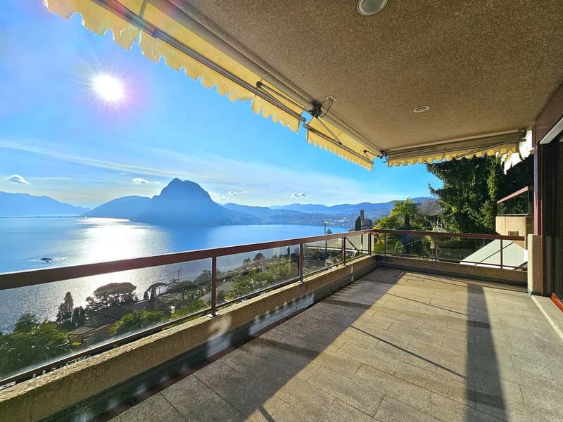 a balcony/terrace with a panoramic view of the lake and mountains