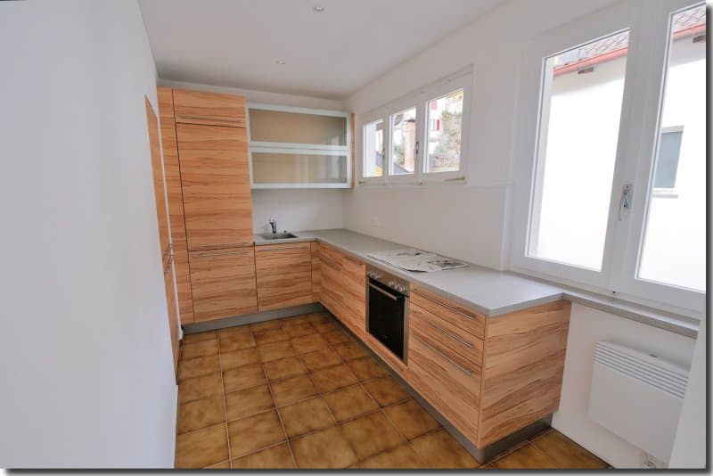 modern kitchen, wooden cabinets, tiled floor, countertop, oven, sink, dishwasher, washing machine, windows