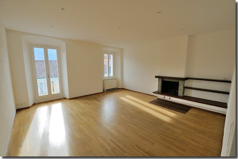 wooden floor, fireplace, large windows, white walls