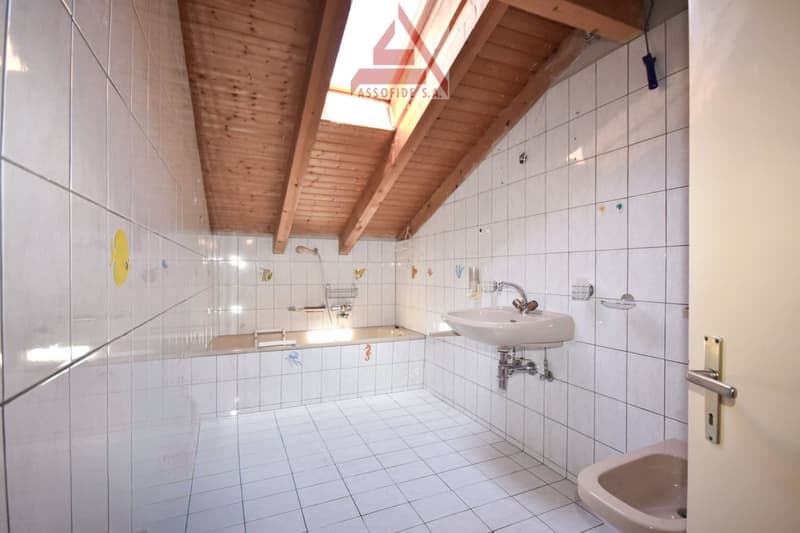 tiled walls, tiled floor, shower, sink, bathtub, wooden ceiling, skylight