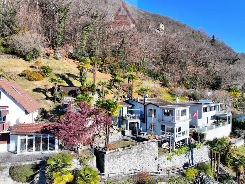 modern house, stone terrace, balconies, multiple stories, elevated on hill
