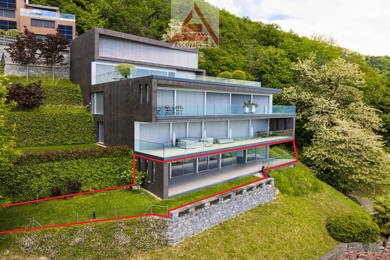 Modern house with terrace and glass windows, built on a sloped area