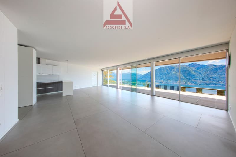 open floor plan, large sliding glass doors, neutral colored flooring, white walls, panoramic view
