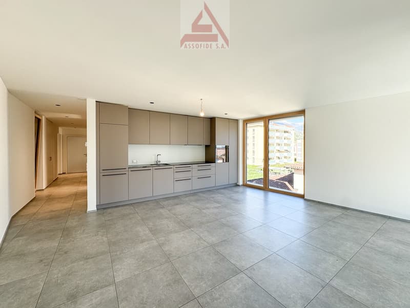 open space, modern kitchen, tiled floor, sliding glass door to the patio
