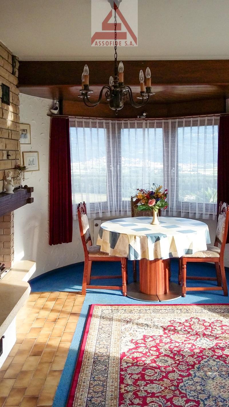 Fireplace, rug, dining table, chairs, view of outside