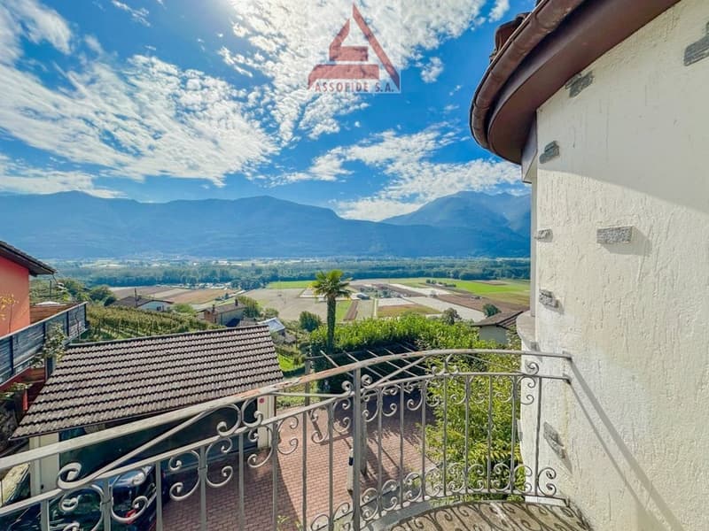 Balcony with a metal railing, view of the mountains and the sky with clouds