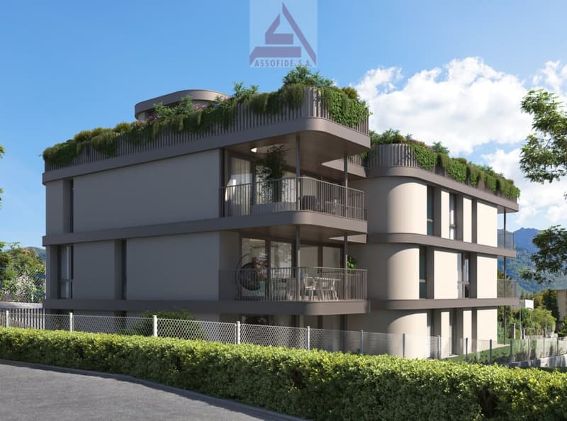 Modern 3-story building, balcony with outdoor seating, green rooftop garden, fenced yard, gray exterior, double-glazed windows