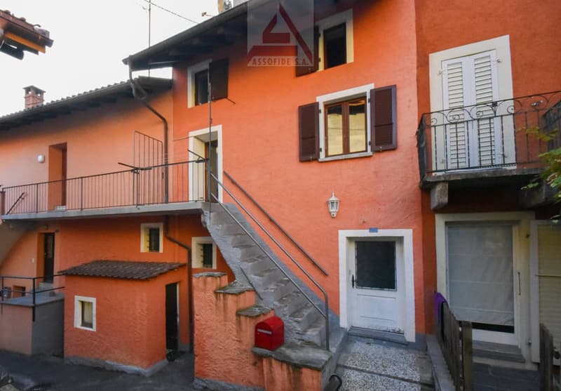 orange house, 3 floors, 3 balconies, red mailbox, chimney