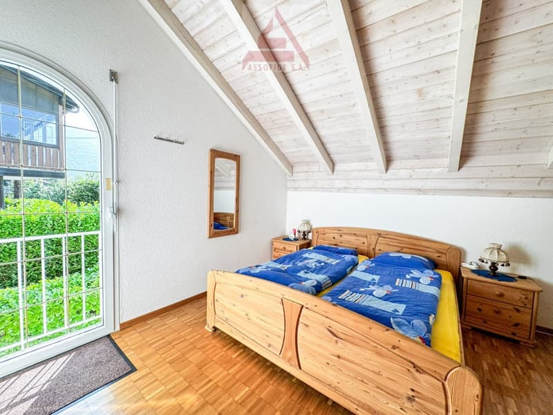wooden bed, blue sheets, wooden nightstands, lamps, mirror, wooden ceiling, glass door, wooden floor, view of the outside