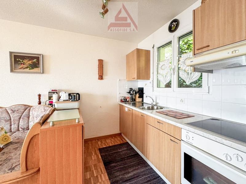 kitchen with dining area, wooden cabinets, white countertops, sink, stove, oven, refrigerator, picture frame, couch, rug