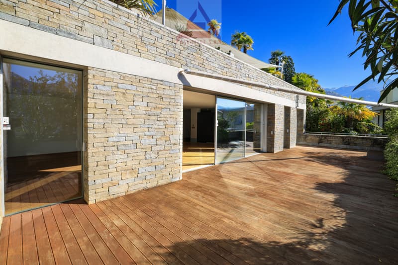 modern house, brick wall, wooden deck, glass doors, glass windows