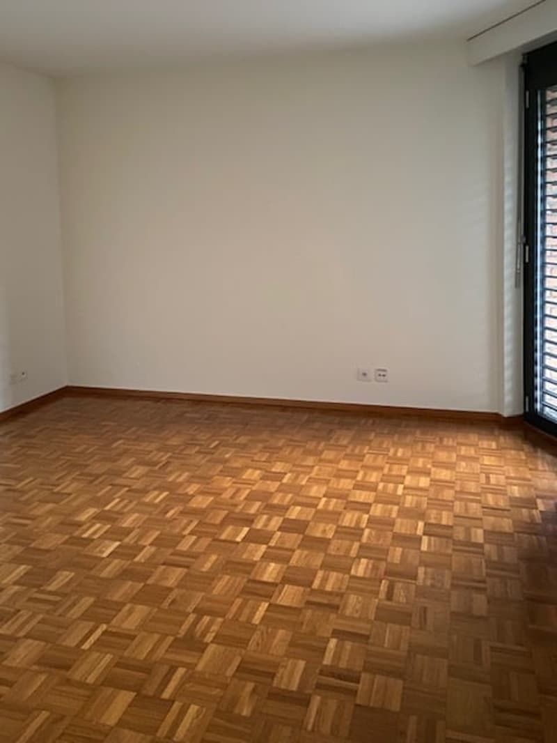 Empty room with wooden floor and white walls