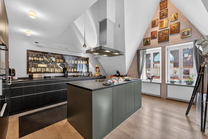 modern kitchen with island, wine rack, large windows, wooden floor