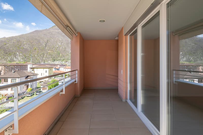 spacious balcony, tile flooring, metal railing, glass doors, mountain view