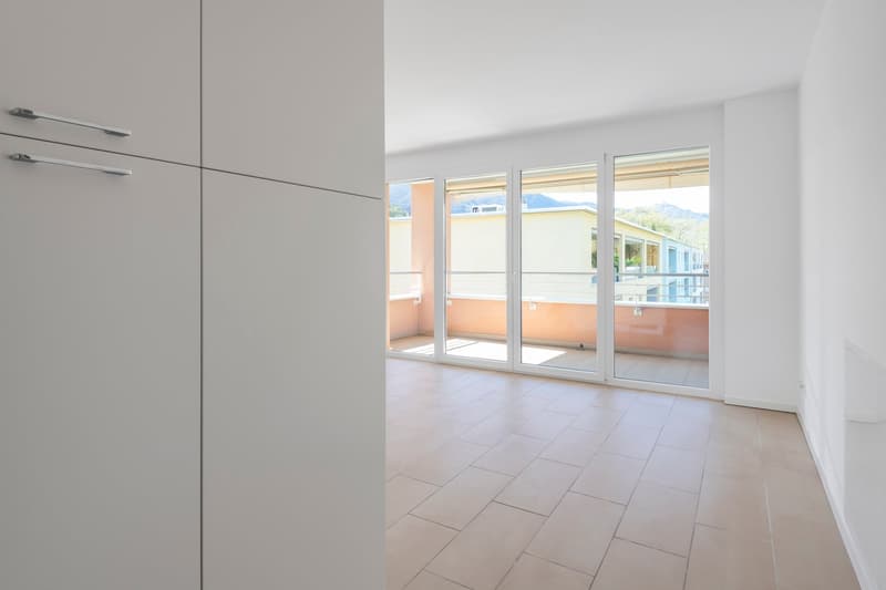 empty room, sliding glass doors, balcony, tiled floor, white walls, modern design