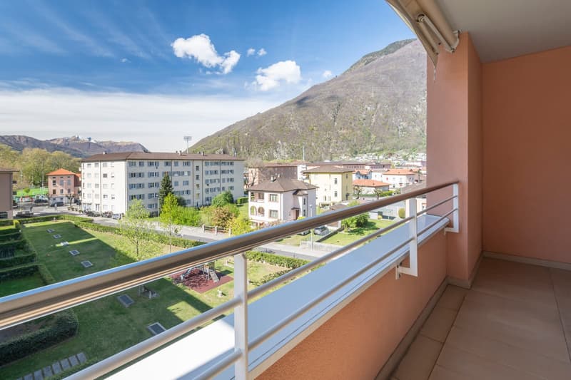 metal railing, tiled floor, large balcony, view of the mountains and town