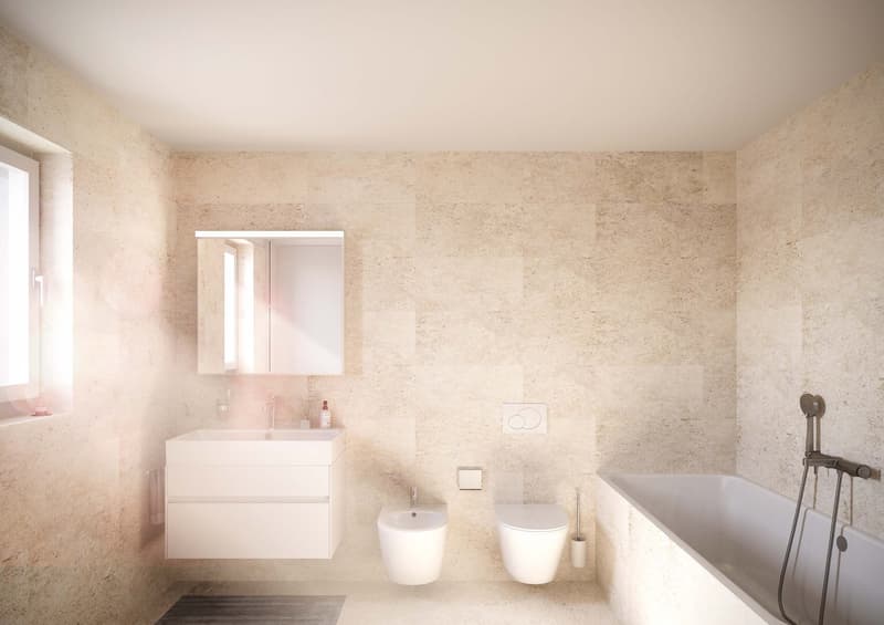 A modern and clean bathroom with beige walls and white fixtures. It includes a bathtub with a showerhead, a bidet, a toilet, a vanity with a sink, and a cabinet. There is also a window with a beige curtain.