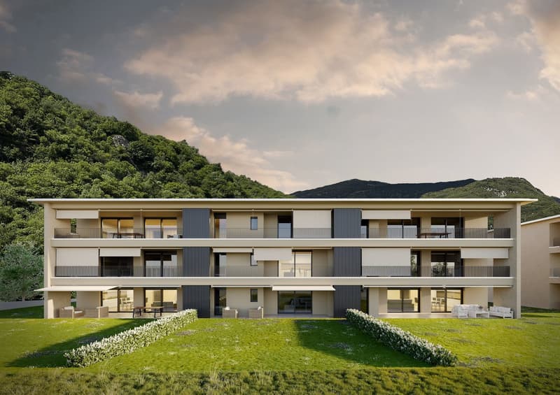 4 story building, beige walls, glass windows, multiple balconies, green lawn