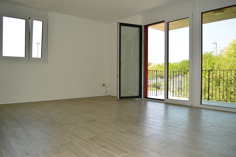 empty room, light tile flooring, three windows, sliding glass doors to balcony