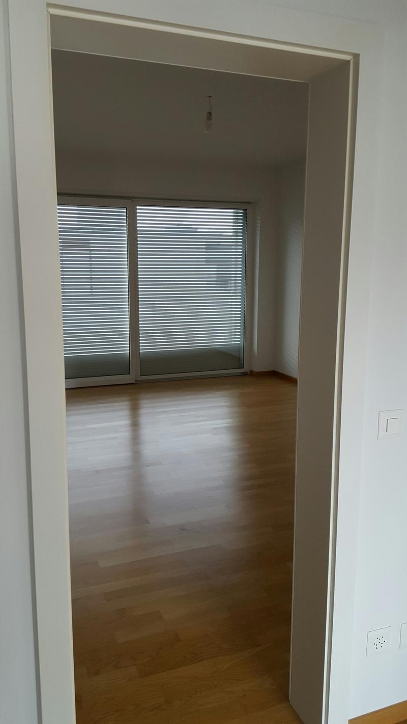wooden floor, open to balcony, large windows, ceiling lamp