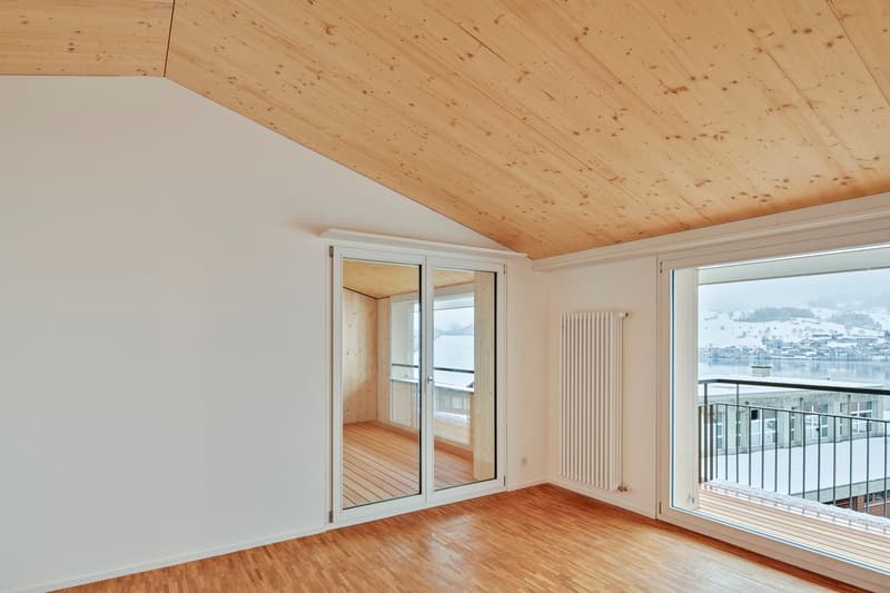 wooden floor, white walls, sliding glass doors, balcony, radiator, scenic lake view