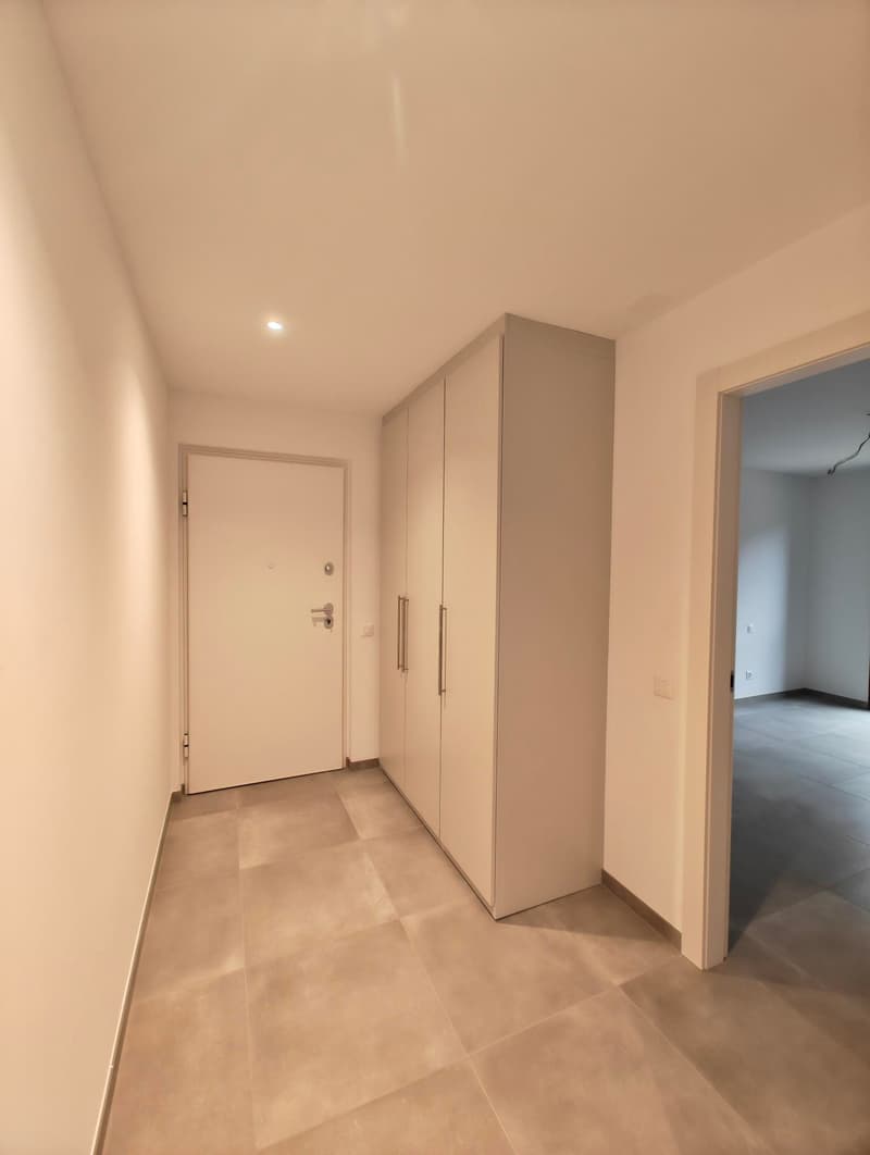 Tiled floor, white walls, two doors, large closet, recessed lighting