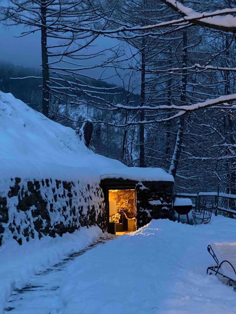 Stone house, covered with snow, open door, winter, snowy landscape