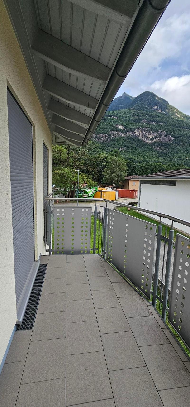 outdoor balcony, steel railing, tiled floor, view of mountain, greenery, clear sky