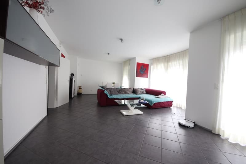 modern living room, red sofa, glass coffee table, large windows with white curtains