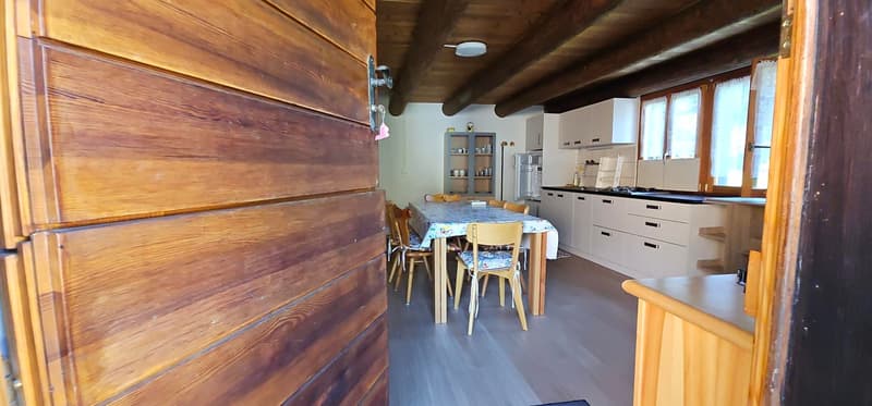 dining room with wooden chairs, a dining table, a fridge, a cabinet, a countertop, wooden ceiling