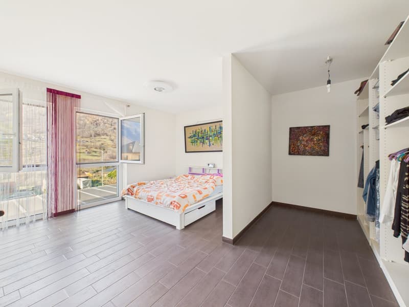 bedroom with bed, windows, paintings, wardrobe, wooden floor