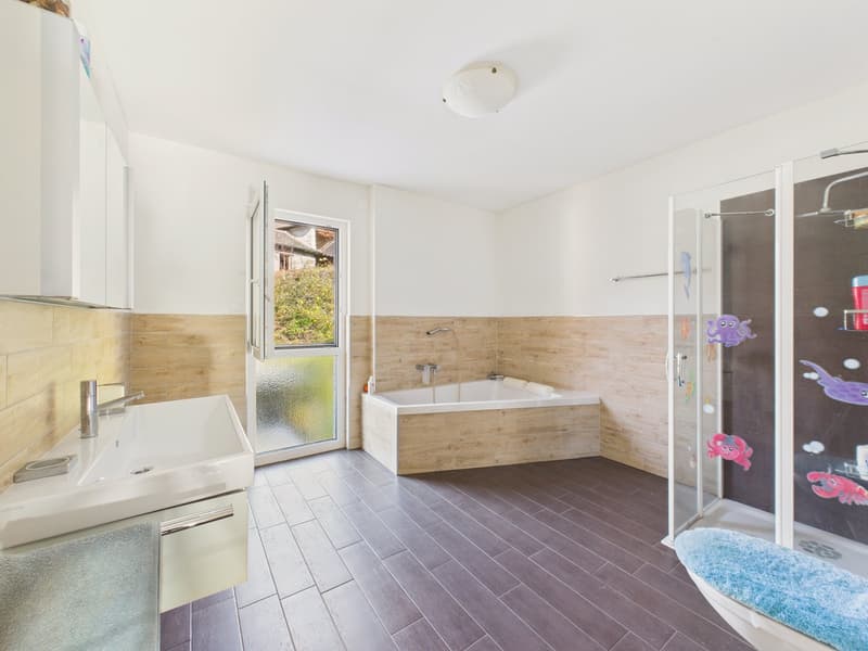 modern bathroom with bathtub, shower, sink, wooden floor, white walls, glass door