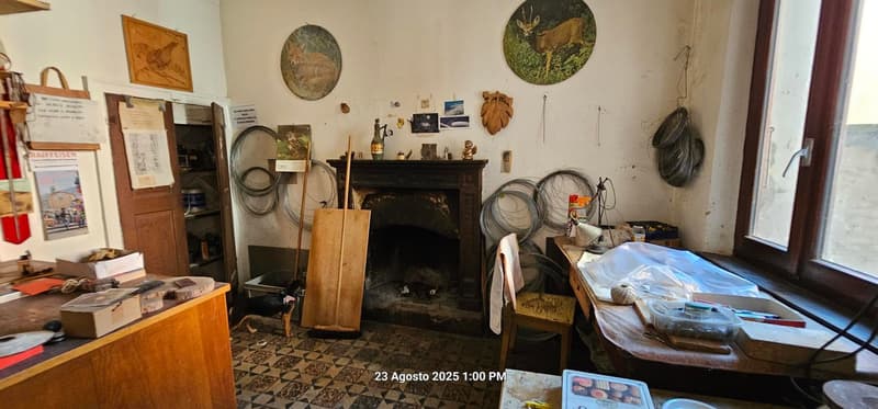 Fireplace, desk, chair, wooden door, storage box, various items on the wall