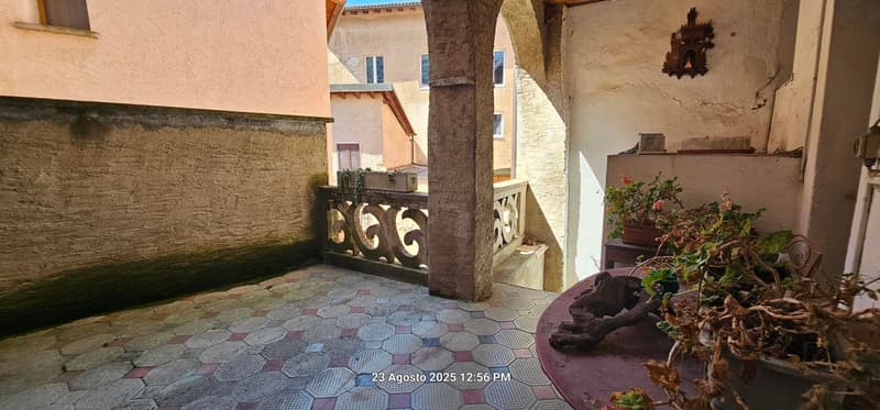 tiled floor, terrace with railings, plants on terrace, decorative item on wall