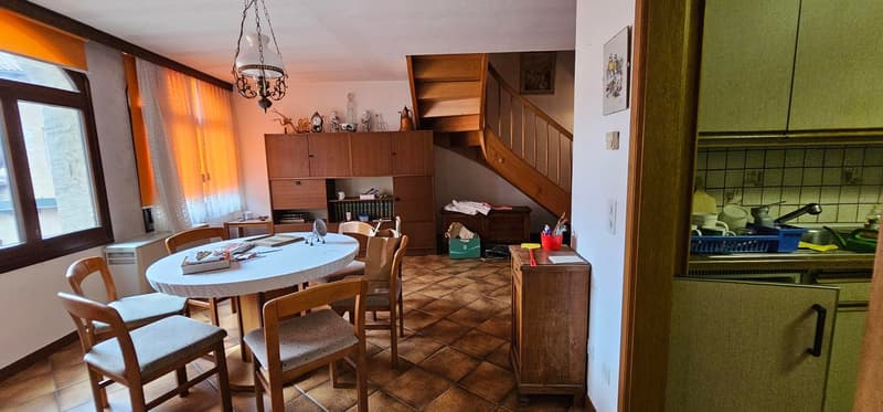 Wooden chairs, dining table, staircase, window with curtain, cabinet, counter, countertop, sink, faucet