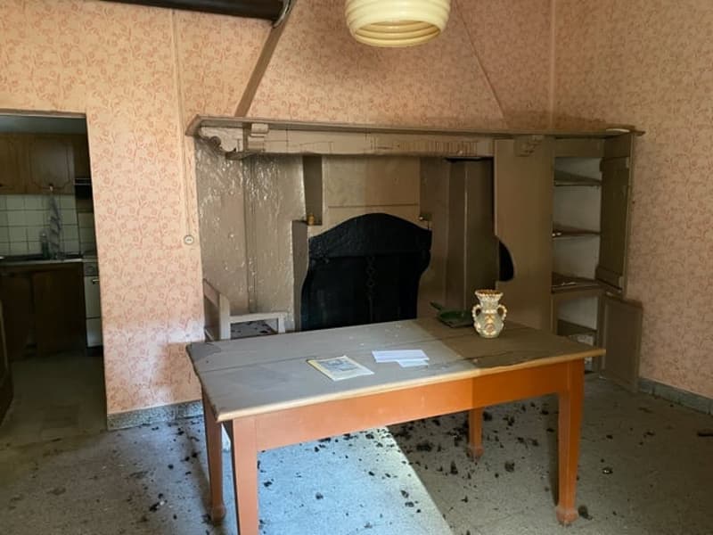 Table in front of fireplace, cabinets on the wall, white tiles