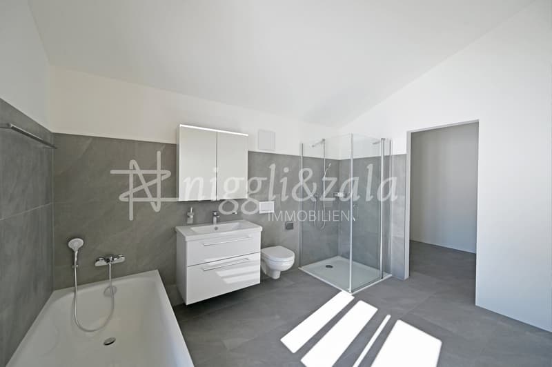 modern bathroom, white bathtub, white sink, white toilet, glass shower enclosure, white cabinets, gray tiles