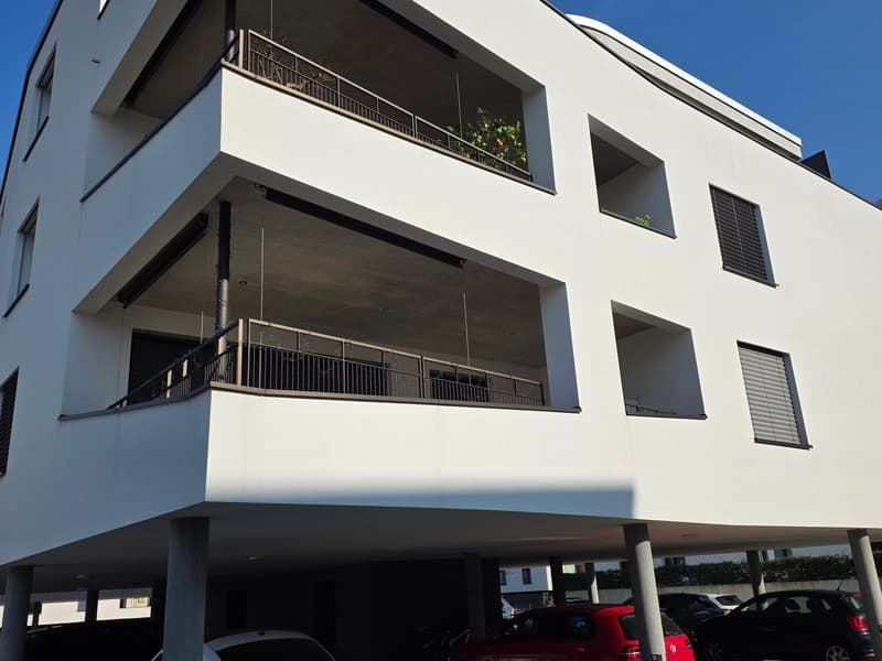 2 story house, white walls, metal balconies, underground parking, multiple windows