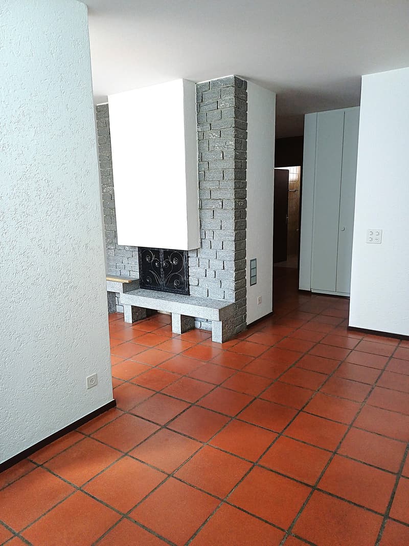 empty room, fireplace, red floor, white walls, power outlets