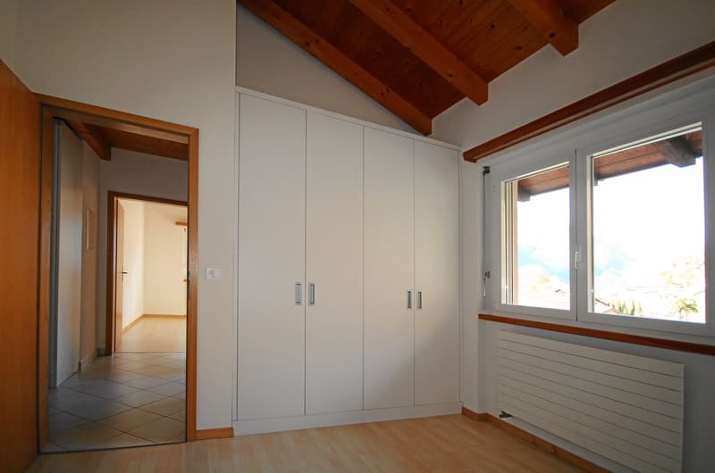 empty room, white wardrobes, wooden floor, wooden beams ceiling, radiator, window
